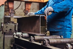 Man is working at metal factory